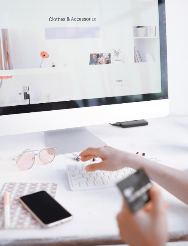A person making an online payment on a laptop using a credit card.
